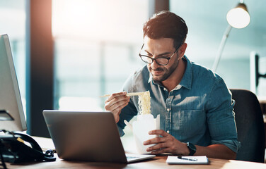 Business man eating lunch at his desk, reading an email on a laptop and working overtime in office....
