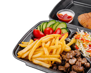 Lunchbox containing pita bread, mushrooms, french fries, and salad