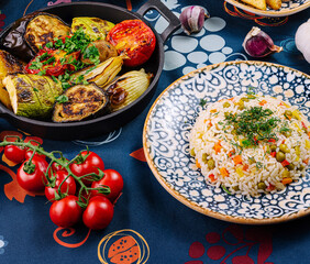 Colorful and flavorful vegetarian dinner is served on a table with a blue tablecloth