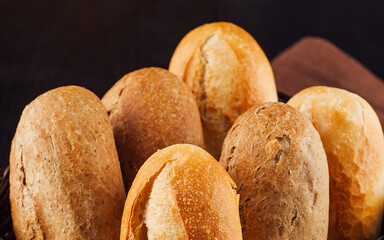 Freshly baked bread rolls resting in a basket