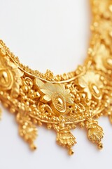 A close-up of a gold necklace laid flat, isolated on a white background, showcasing intricate detailing