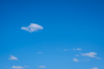 small white cumulus clouds in blue sky