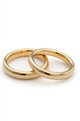 A pair of gold wedding bands isolated on a white background, perfectly positioned for symmetry and shine