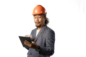 Indonesian male construction worker standing confidently and optimistically carrying a tablet and a cup of coffee, industrial and construction concept, isolated white background.

