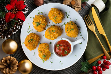 Homemade chicken nuggets with tomato sauce. Top view table with Christmas decoration.