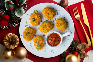 Homemade chicken nuggets with tomato sauce. Top view table with Christmas decoration.