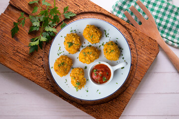 Homemade chicken nuggets with tomato sauce. Top view table with decoration.