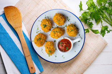 Homemade chicken nuggets with tomato sauce. Top view table with decoration.