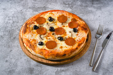 Top view of pepperoni, mushroom and olive neapolitan pizza