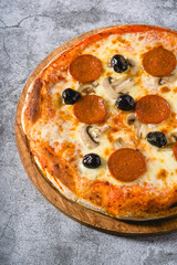 Top view of pepperoni, mushroom and olive neapolitan pizza