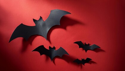 Naklejka premium black cardboard bats on bright background with space for text, halloween concept