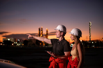 Engineers wearing dressed casually , hard hats examining survey stand  tablet discussing on screen...