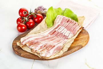 Sliced pork bacon oved board