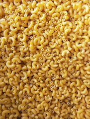 Uncooked elbow yellow macaroni dry pasta gomiti raw cornettes pile, image stockphoto photo, 
