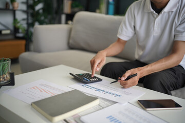 Man using calculator calculate finance and another hand holding pen