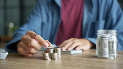 Man planning finances Count banknotes and coinsใ