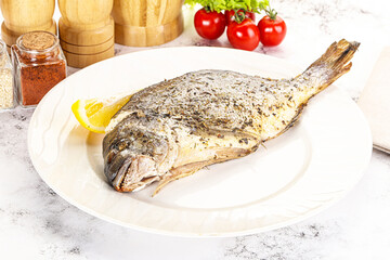 Baked Dorado fish served lemon