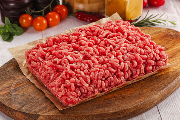 Raw minced beef meat over board