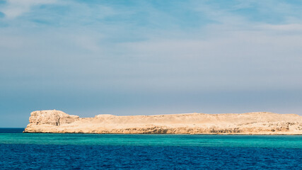 rocky coast of the Red Sea and.blue sky with clouds