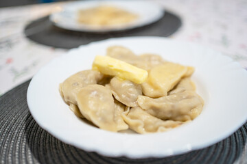 Varenyky, dumplings on a plate with a butter. Ukraine cuisine, natural homemade food