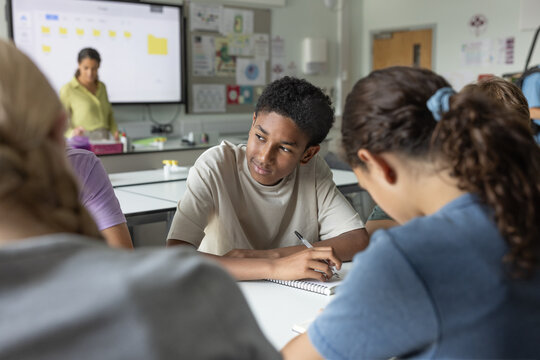 African American boy student looking out of the window in class