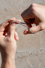 A man trims his fingernails. A man trims his fingernails with manicure scissors