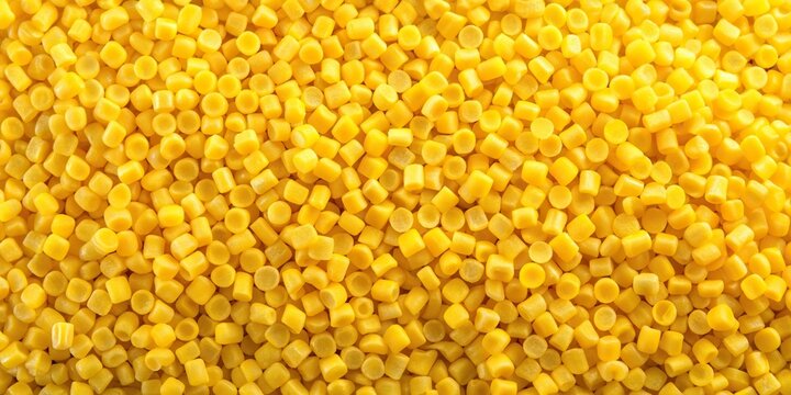 Aerial view of yellow resin pellets used for hot melt adhesives