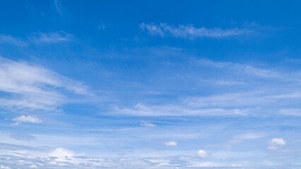 Obraz premium clear blue sky background,clouds with background, Blue sky background with tiny clouds. White fluffy clouds in the blue sky. 