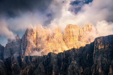Detailed landscape view of colorful mountain range with dramatic light, Dolomites