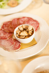 Close up on italian traditional northern food on a restaurant table. Many dishes are visible.