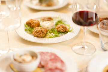 Close up on italian traditional northern food on a restaurant table. Many dishes are visible.