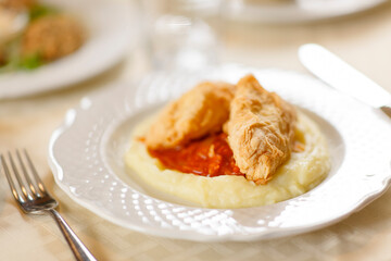Close up on italian traditional northern food on a restaurant table. Many dishes are visible.