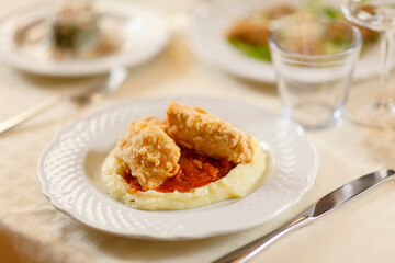 Close up on italian traditional northern food on a restaurant table. Many dishes are visible.