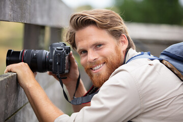 smiling hiker taking photos outdoors