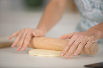 woman hands rolling out dough