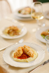 Close up on italian traditional northern food on a restaurant table. Many dishes are visible.