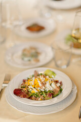 Close up on italian traditional northern food on a restaurant table. Many dishes are visible.