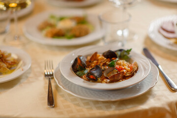 Close up on italian traditional northern food on a restaurant table. Seafood pasta recipe.