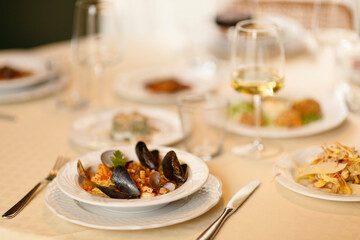 Close up on italian traditional northern food on a restaurant table. Seafood pasta recipe.