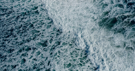 Drone Aerial top view blue sea wave rolling  foamy 