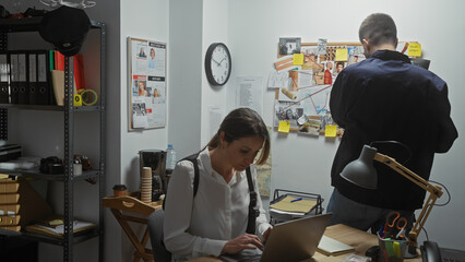 Woman and man investigating in a room with corkboard, evidence, surveillance and photos.