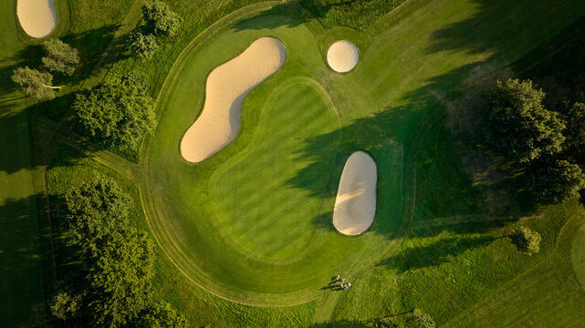 Aerial View of Golf Course Green and Bunkers, howcasing a well-maintained green surrounded by sandy bunkers.