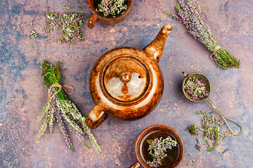 Cup of tea and branch of heather.