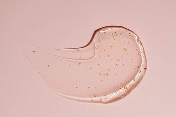 Luxurious gold flecked cream gel texture on pink