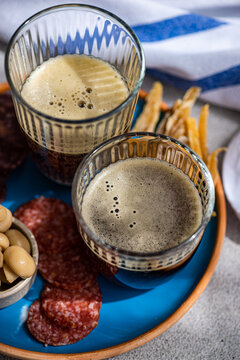 Traditional kvass drink with various snacks on a rustic setting