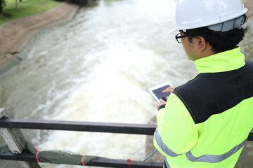 Civil Engineer inspects the construction of a large sewage-water treatment pipe unfinished