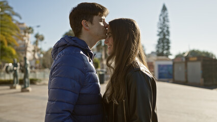 A loving couple embraces on a sunlit city street, embodying romance and companionship in an urban setting.