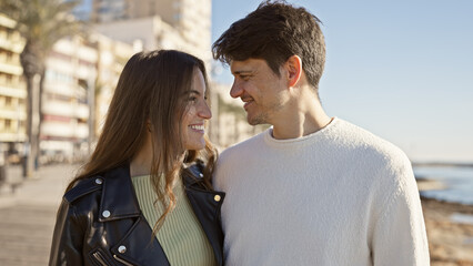 Affectionate couple embracing seafront outdoor