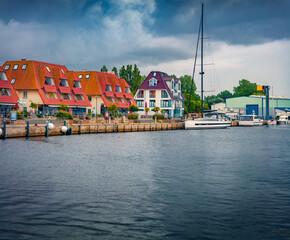 Dramatic summer cityscape of Wiek port with a boats and yacht, Germany, Europe. Gloomy morning...