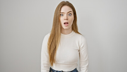 Obraz premium Surprised young caucasian woman with long blonde hair against a white background.
